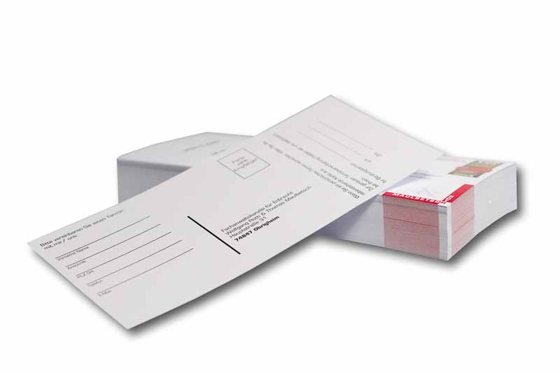 Postkarten-Mailing Druckerei Mosbach Werbepostkarten auf einem Stapel, die oberste ist seitlich heruntergerutscht